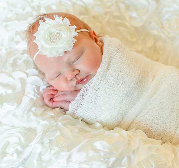 Baby on white silk blanket
