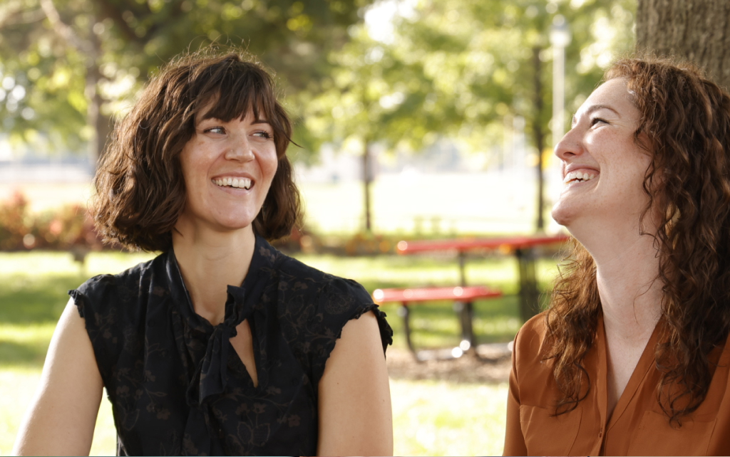 Two students laughing outside