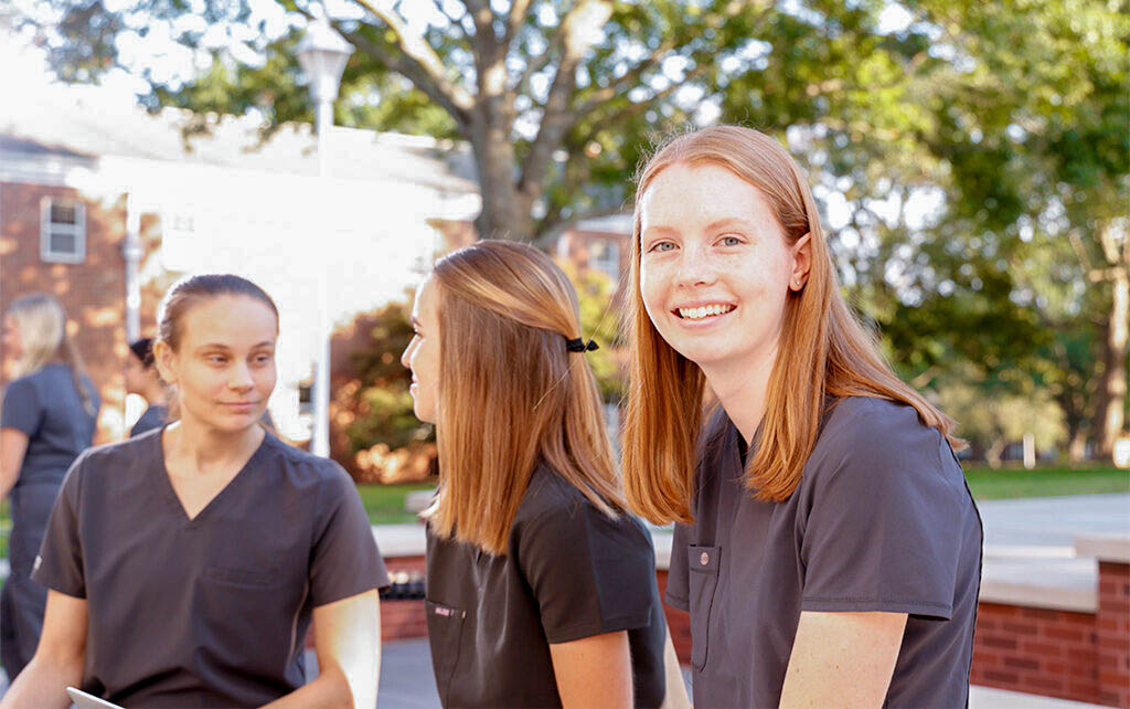 Nursing students sitting outside