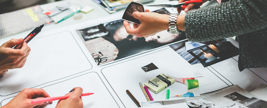 Designers creating a layout on paper