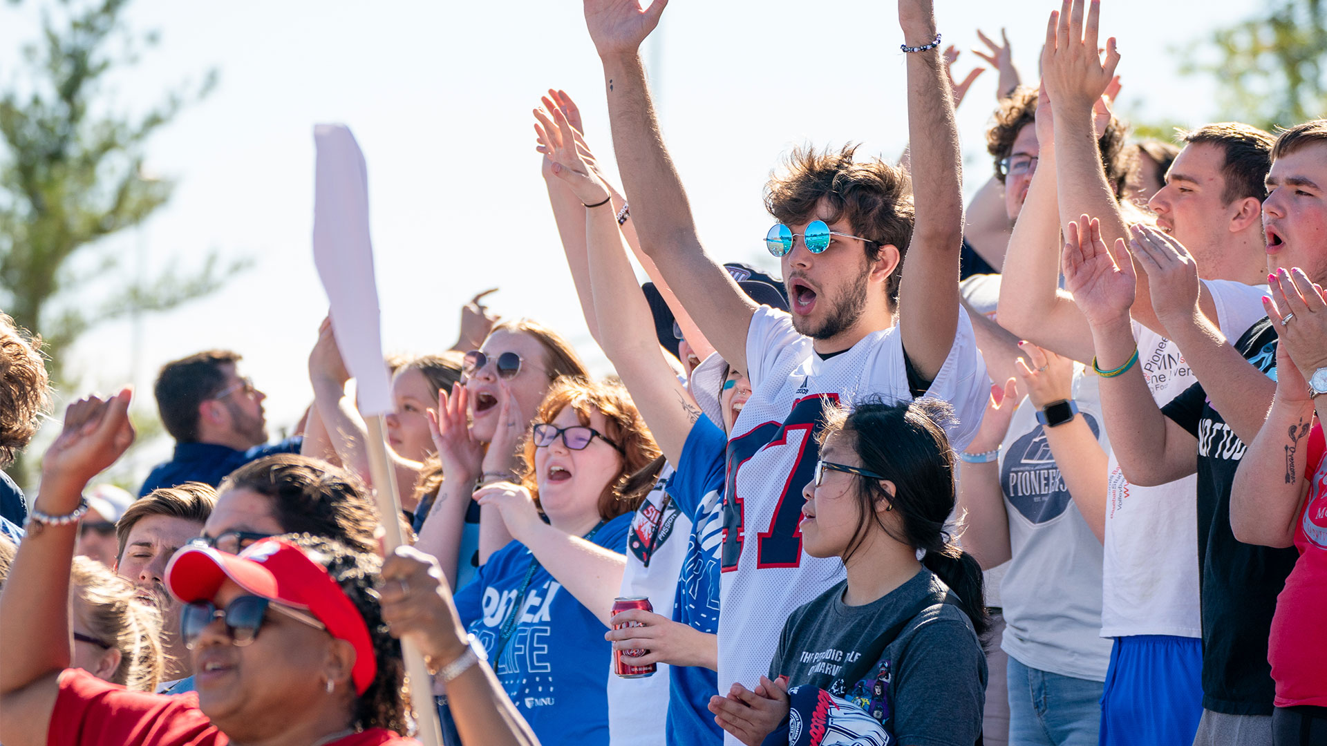 MNU students cheering at the homecoming football game.