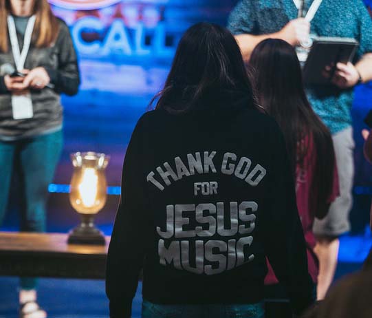 girl with hoodie on that reads Thank God for Jesus Music