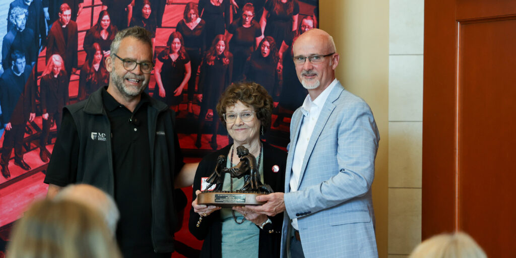 Todd Frye, Mary Fry and Jon North as Mary Fry is awarded the Excellence in Play Therapy award