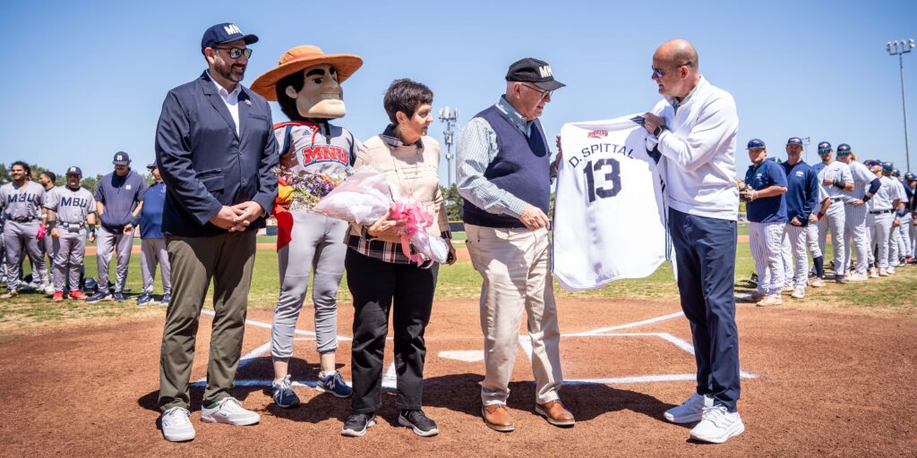 Dr. Spittal is presented a custom Spittal number 13 baseball jersey at the home baseball game.