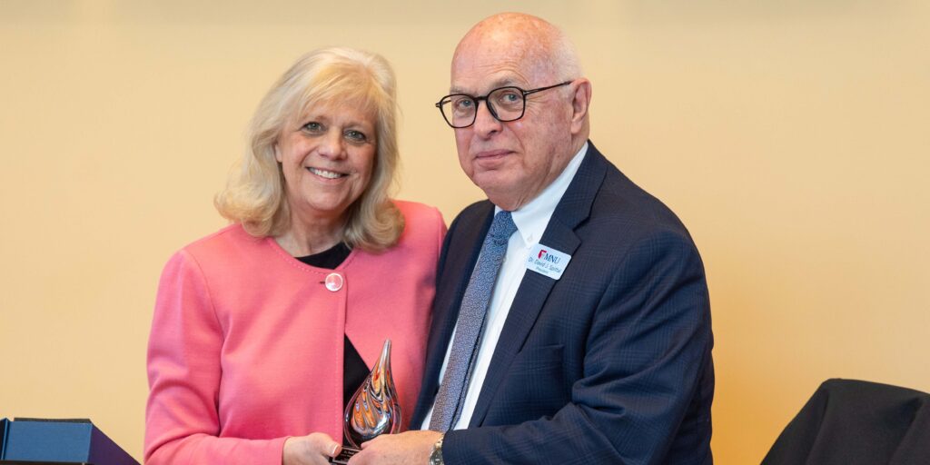 Dr. Carla Sunberg, GS, presents Dr. Spittal with award from the Church of the Nazarene denomination.