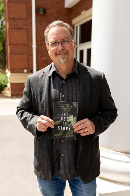 Daniel Schwabauer holding his published book