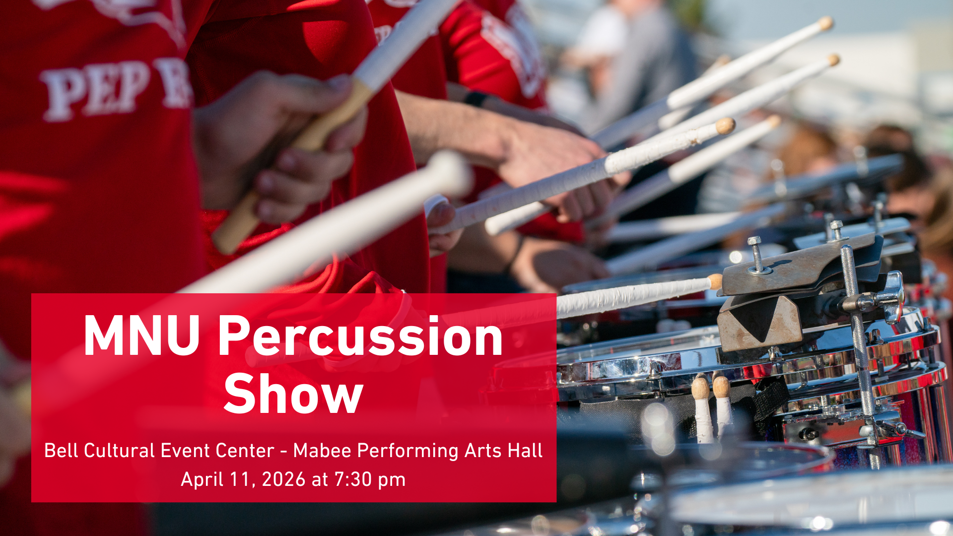 Closeup of the MNU Percussion players playing in the stadium stands
