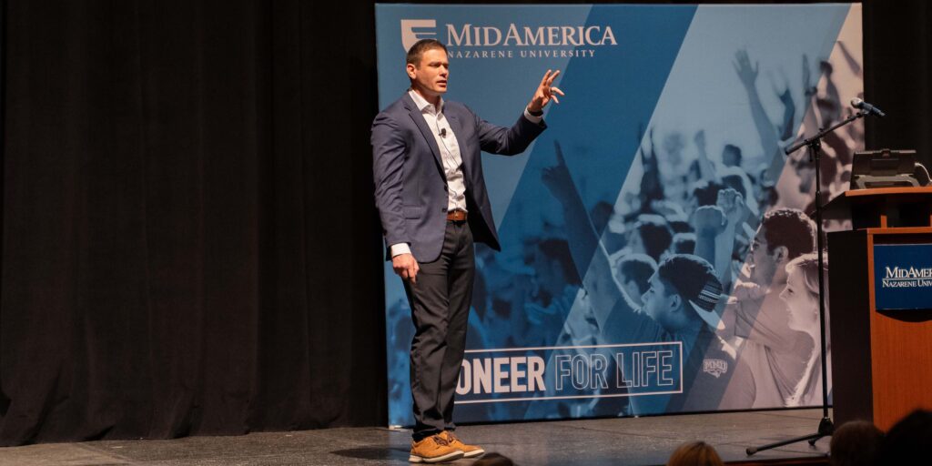 Justin Pickens speaking on stage