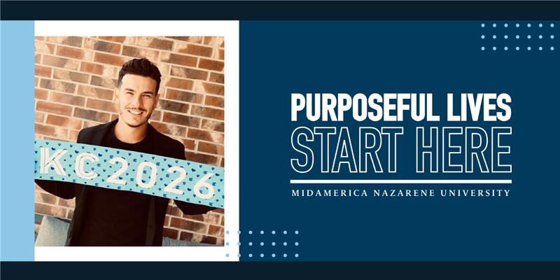 Yann Passet holds a KC 2026 sign indicating the FIFA World Cup will be in Kansas City in 2026