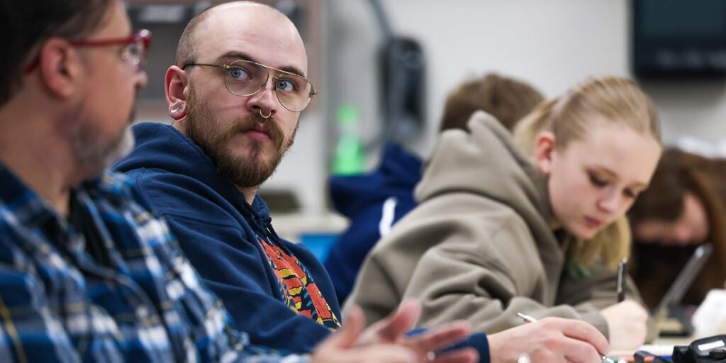 Students listen and take notes about documenting evidence.