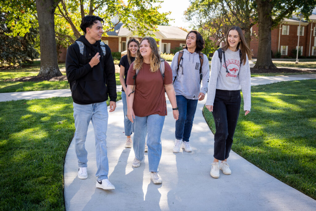 a group of students walk together on MNU's campus