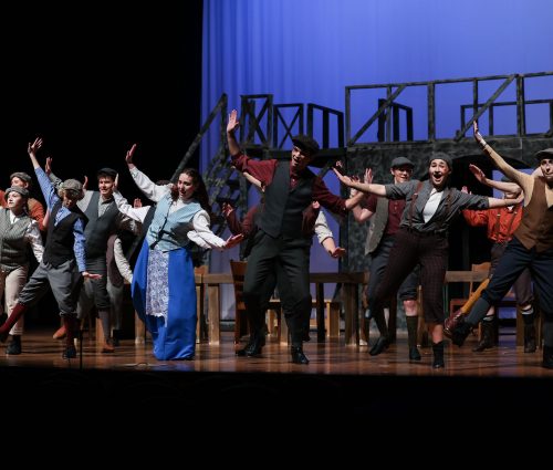 Image of students dancing in Newsies musical.